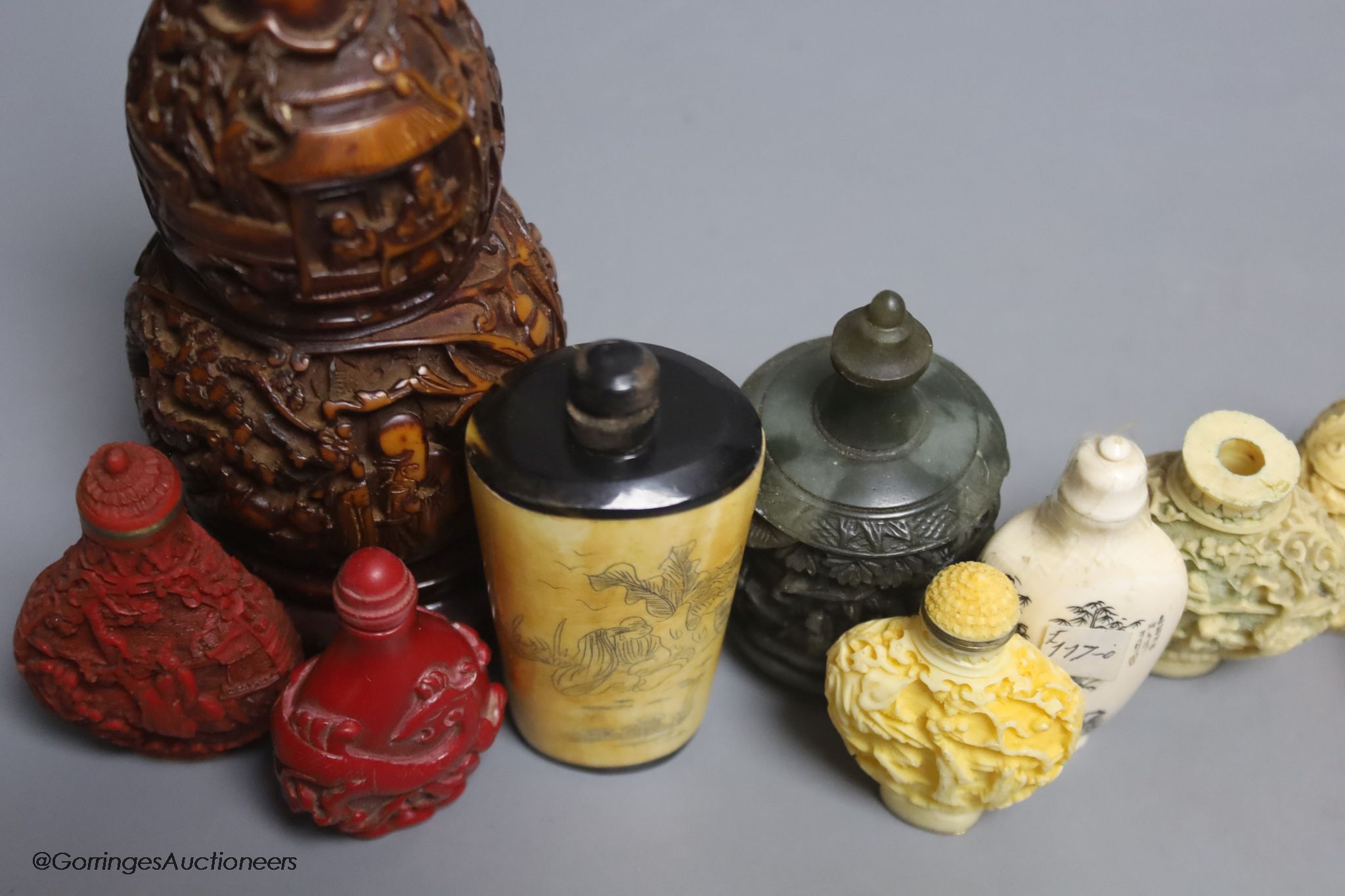 A large Chinese 20th century carved snuff bottle and smaller snuff bottles